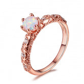 Stunning rose gold-plated solitaire ring with a vibrant opal stone and shimmering cubic zirconia details.